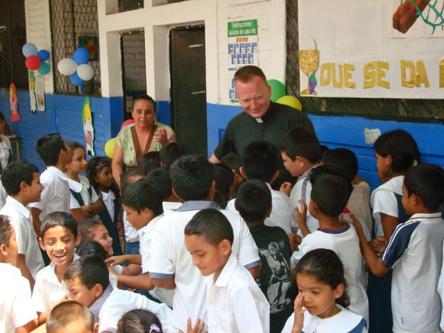 Father Keane greets students at Nuestra Senora del Refugio